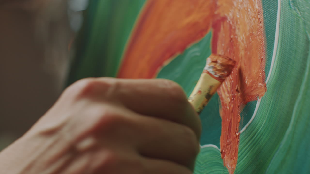 Close-Up of Artist Holding Palette and Painting on Canvas