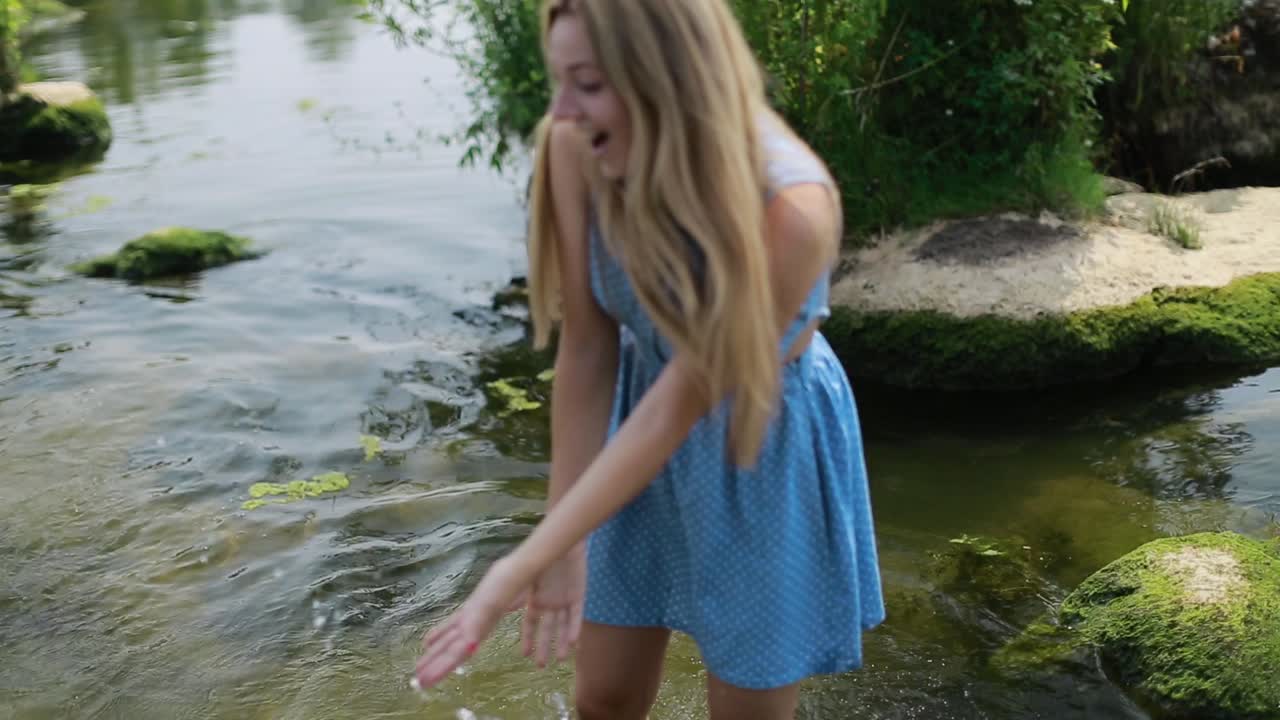 Romantic Couple Enjoying Outdoors. Handsome guy and beautiful girl resting in river