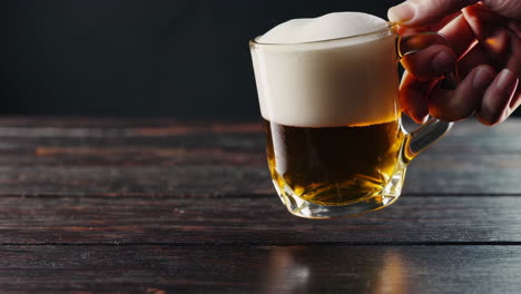 glass of beer on wooden table