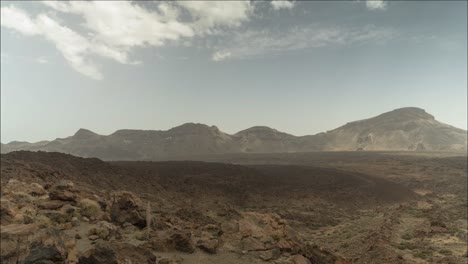 clouds rolling over mountain range in tenerife, teide national park