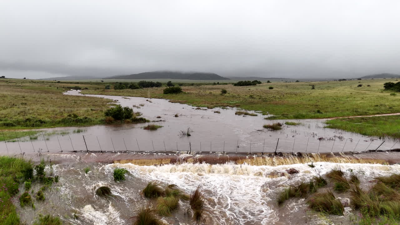 Aerial view of rural countryside farm fence compromised by heavy floodwater