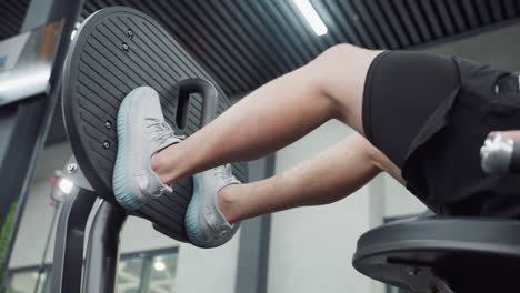 leg view of gym enthusiast pushing leg extension machine, showing tense calf muscles engaged in controlled extension under modern gym lighting emphasize strength endurance and focused technique