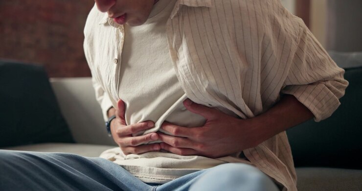 Young Man Suffering From Severe Stomach Pain at Home