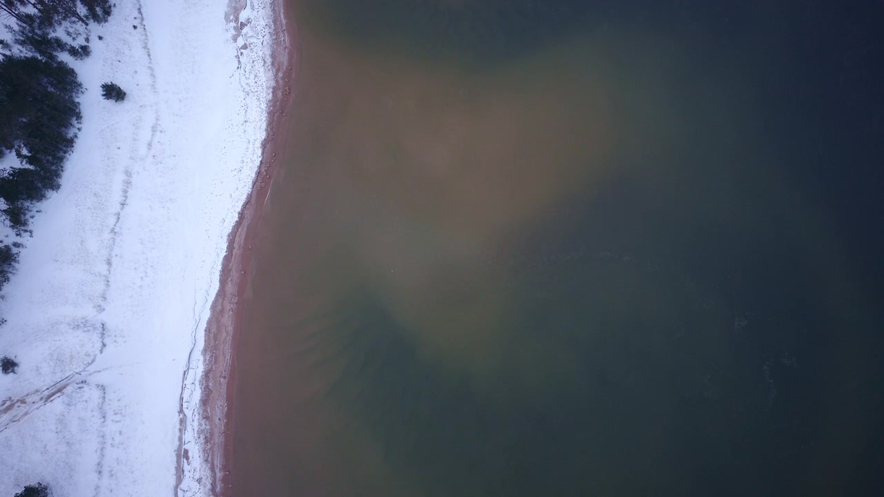 Cinematic drone shot of Lake Superior and its rugged winter coastline in the Upper Peninsula of Michigan