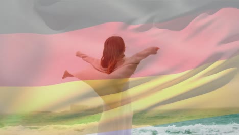 Animation-of-flag-of-deutschland-over-caucasian-woman-at-beach