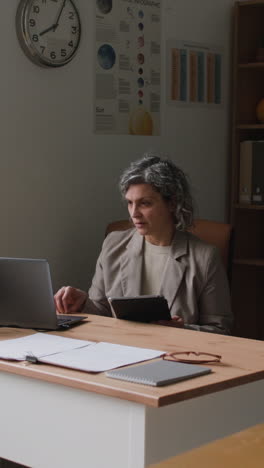 woman working at a desk in a classroom