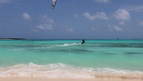 man start to fly kitesurf on tropical shallow sea waters go to deep sea ocean