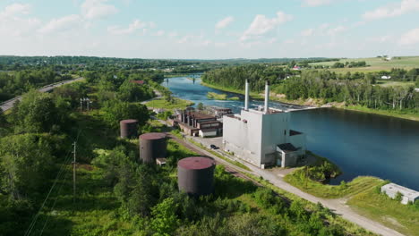 aerial view from behind hydroelectric power plant: railroad, tanks, and dam in sight