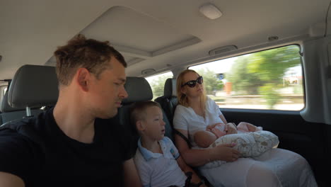 parents with children traveling by car