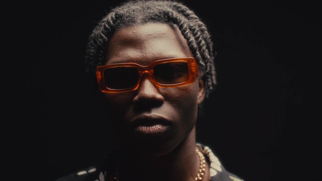 Portrait of Young Black Man in Sunglasses Posing with Confidence in Studio