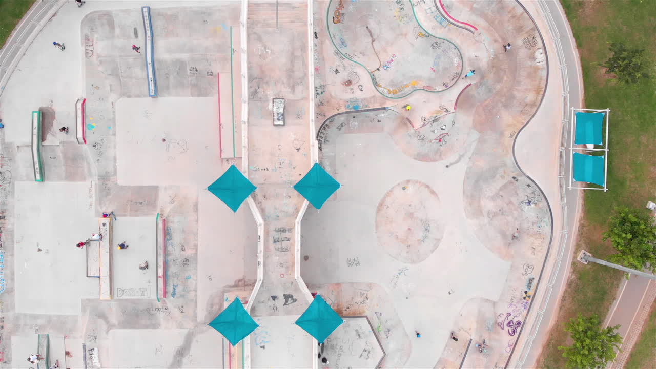 Drone footage Above Skatepark with People Skating