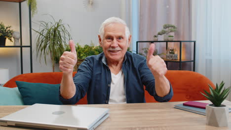 happy senior old man looking approvingly at camera showing thumbs up like positive sign good news