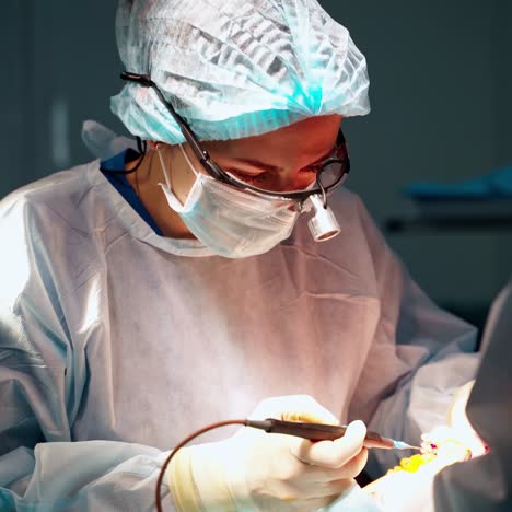 female surgeon in operation room with reflection in glasses. modern equipment in operating room