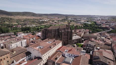 aerial orbit around landmark gothic cathedral in city plasencia in spain, summer