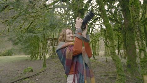 woman taking pictures in a forest