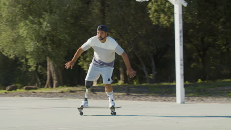 active young guy with leg prosthesis skateboarding