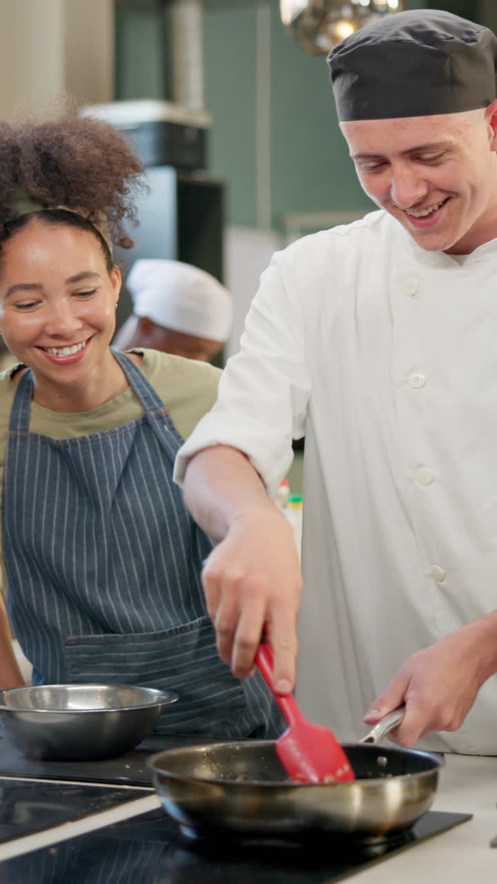 Two chefs cooking in a kitchen
