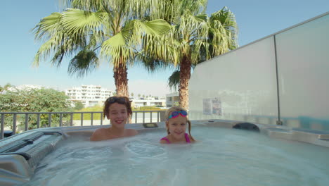 Siblings-enjoying-hot-tub-together