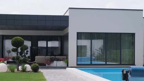 modern exterior of the house. house with its own territory and large panoramic windows. a small suburban house in a modern style.