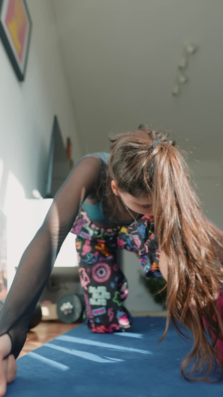 Young Woman Stretching on Yoga Mat at Home