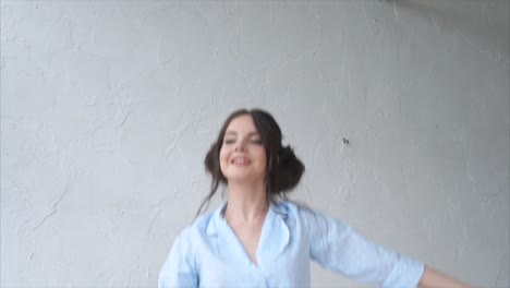 joyful woman playing with pillows