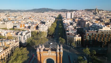 cinematic aerial pullback reveals famous arc de triumph in barcelona, spain