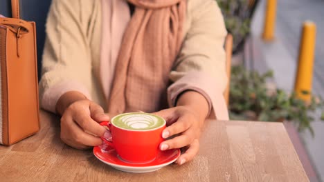 woman enjoying matcha latte outdoors