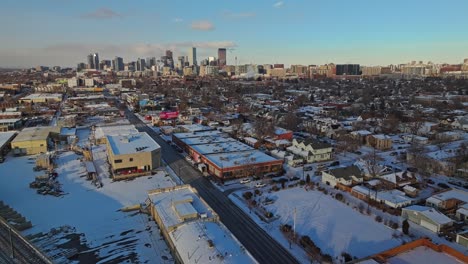 aerial orbit above industrial outskirt suburb in denver colorado at winter sunset