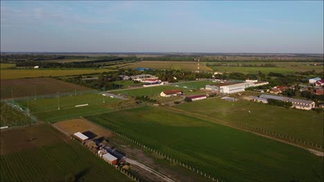 Drone-flying-over-a-field-with-a-football-field-in-the-frame