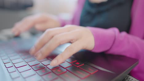 a close-up woman sitting on a sofa press to type information computer laptop for shopping online at home