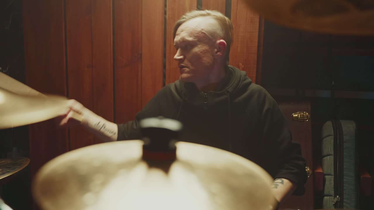 Drummer Practicing in a Home Studio