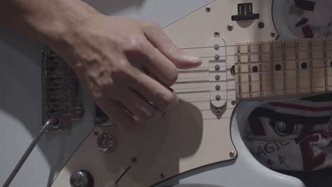 close-up man playing electric guitar