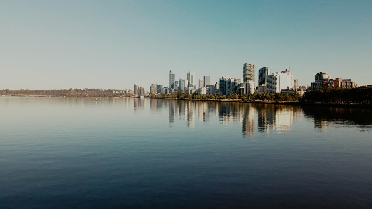 Skydiving over Perth city skyline on a blue sky day.