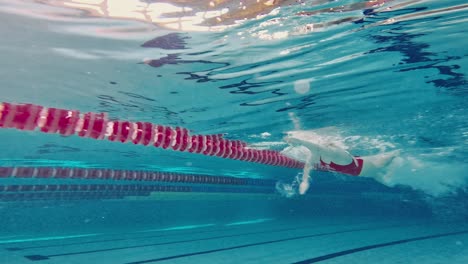 woman swimming underwater in a pool