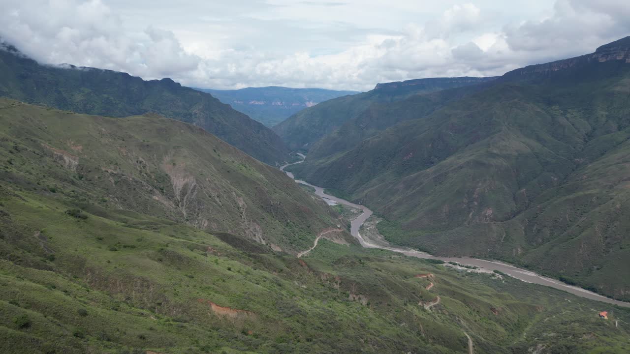 Aerial view of the stunning Chicamocha Canyon (Cañón del Chicamocha) in the Santander region of Colombia, showing dramatic mountain ridges and the winding Chicamocha River in the Andean landscape
