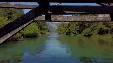 Flying-under-the-bridge-on-river,-route-of-the-seven-lakes-,-drone-view