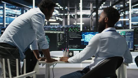 server hub manager checking ai data analytics graphs, congratulating worker