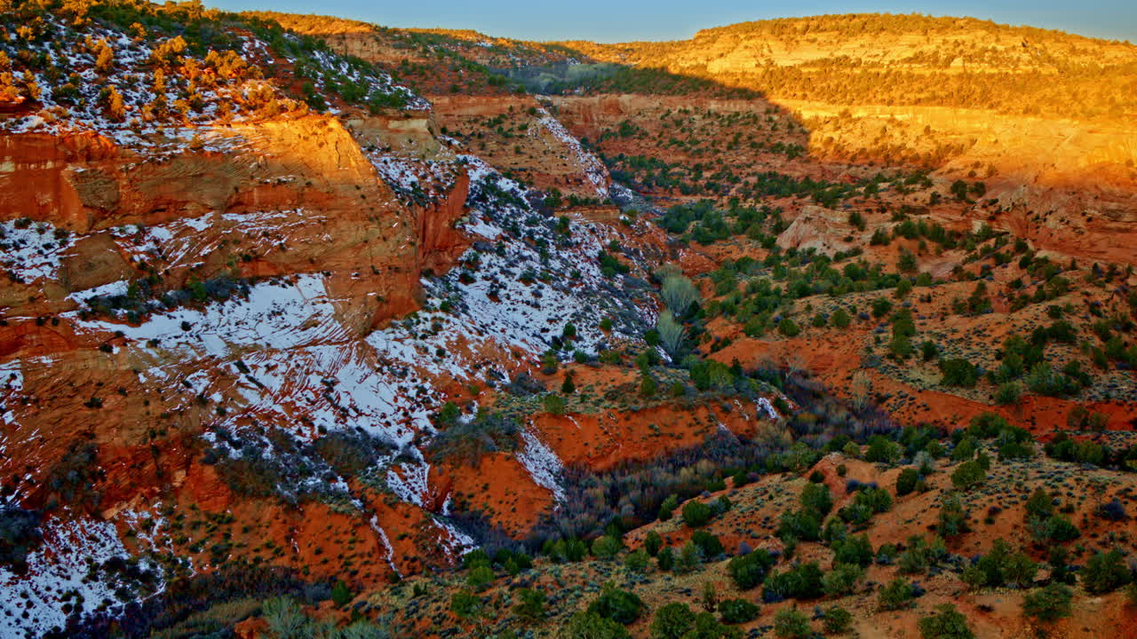 A slow-moving drone shot captures the vivid hills, unusual rock formations, and towering hoodoos near the Utah-Arizona border.