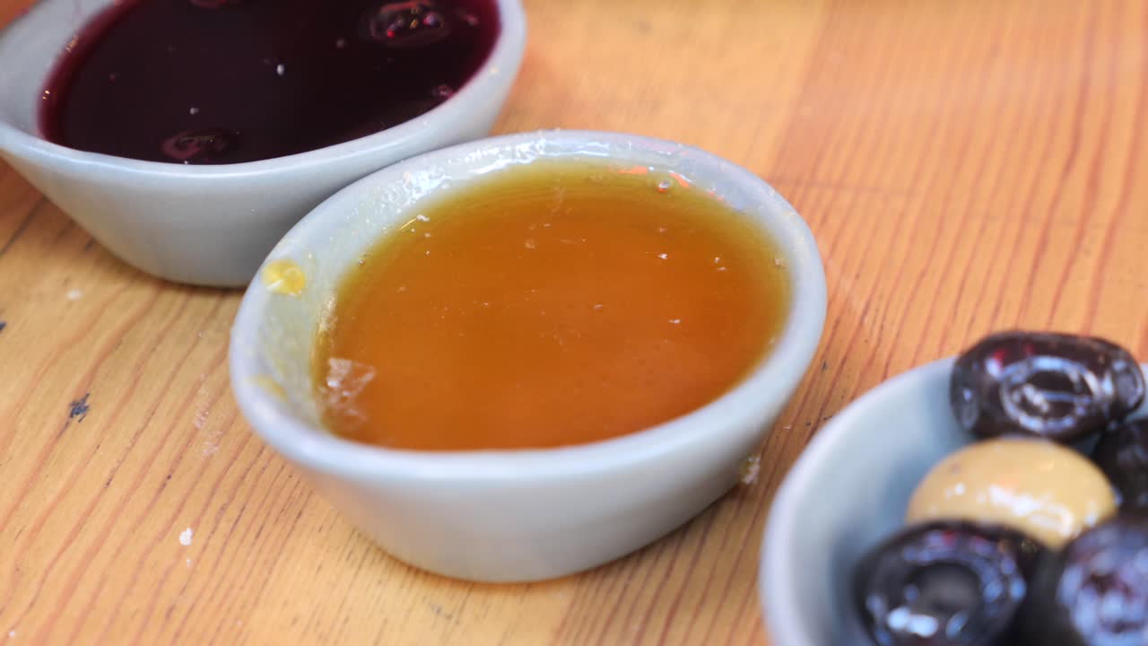 Breakfast spread with honey, jam, and olives