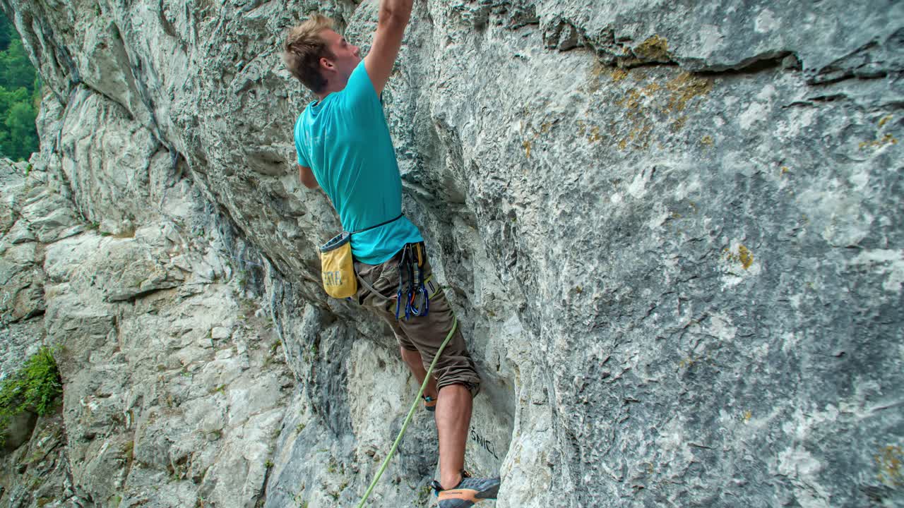 millennial handsome rock climber elevating at Burjakove Peci Topla