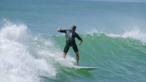 Slow-motion-video-of-male-surfer-at-Waihi-Beach,-New-Zealand