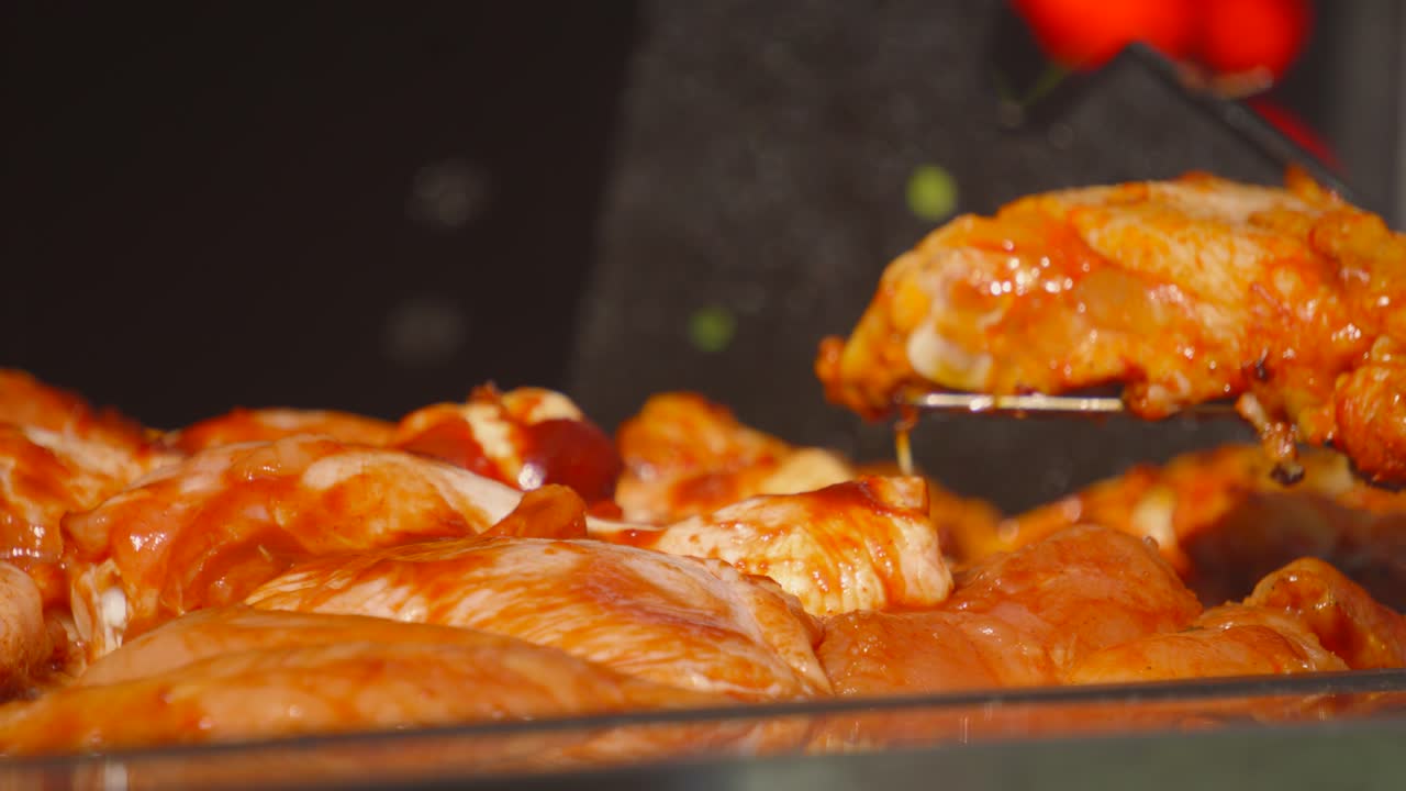 Lots of Marinated Raw Chicken Fillets Being Cooked on BBQ in Soft Sunlight as Meat is Gently Cooked on BBQ and Tended to by Chef. Lean High Protein Outdoor Summer Cooking Food.