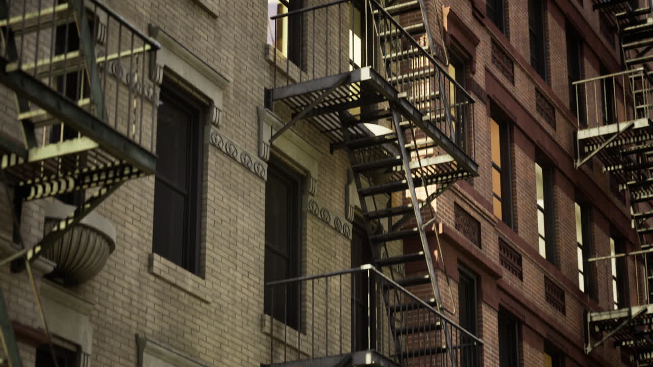 Urban architecture with fire escapes illuminating at twilight