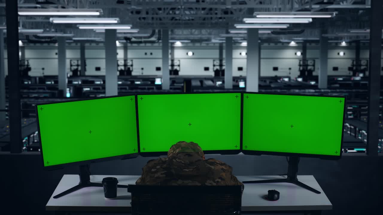 데이터 센터에서 모의 다중 컴퓨터 모니터와 함께 작업하는 동안 잠을 자는 피곤한 아시아 군인의 뒷면