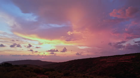 vibrant sunset over rolling hills with colorful clouds in the evening sky