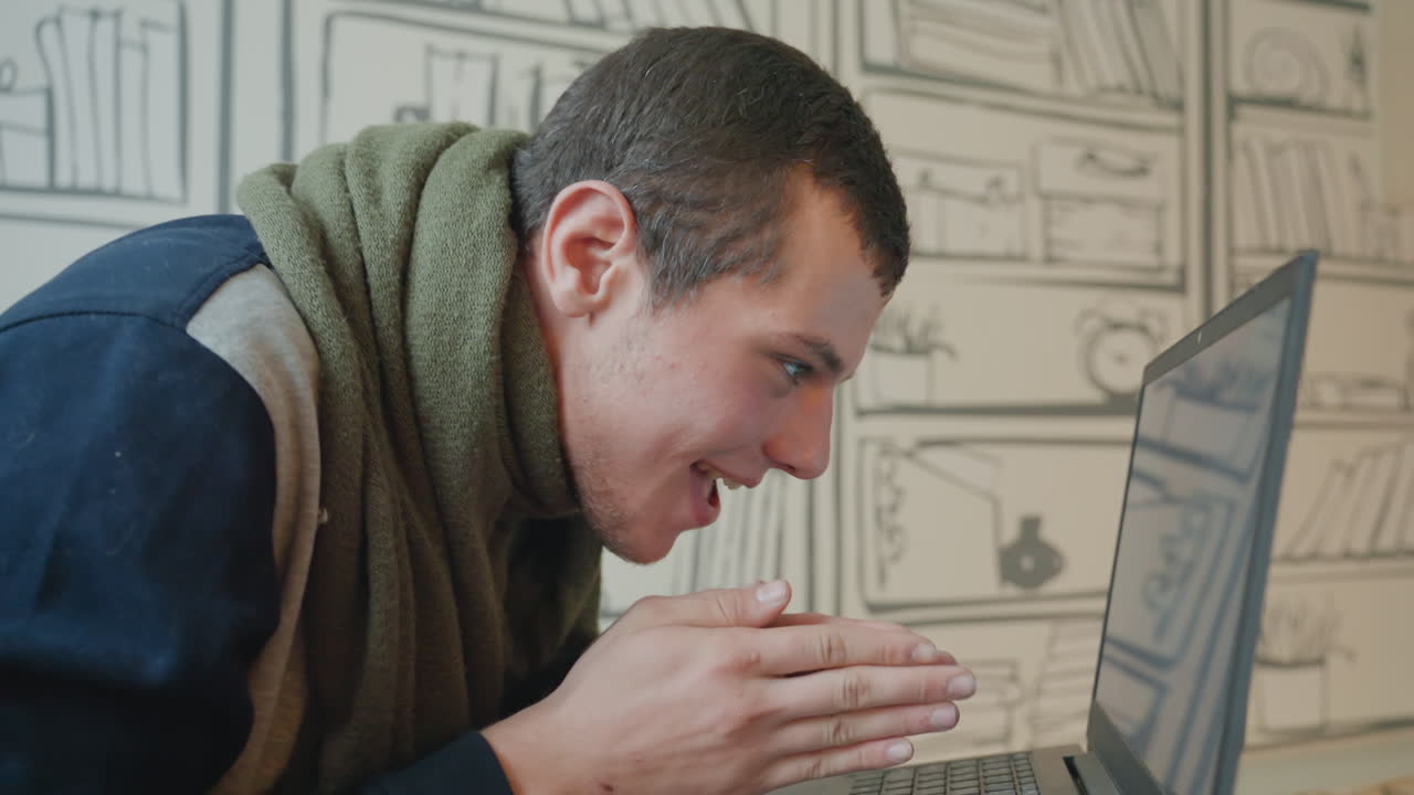 White student smiling at laptop, cozy library wallpaper, green scarf, casual sweater, eager typing, playful discovery, warm daylight, close up hands, relaxed posture, creative project