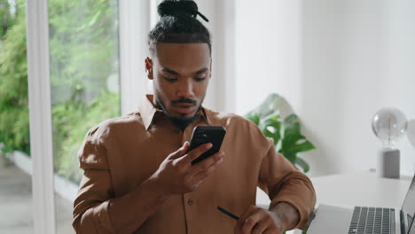 attentive freelancer listening smartphone message closeup. guy using cellphone