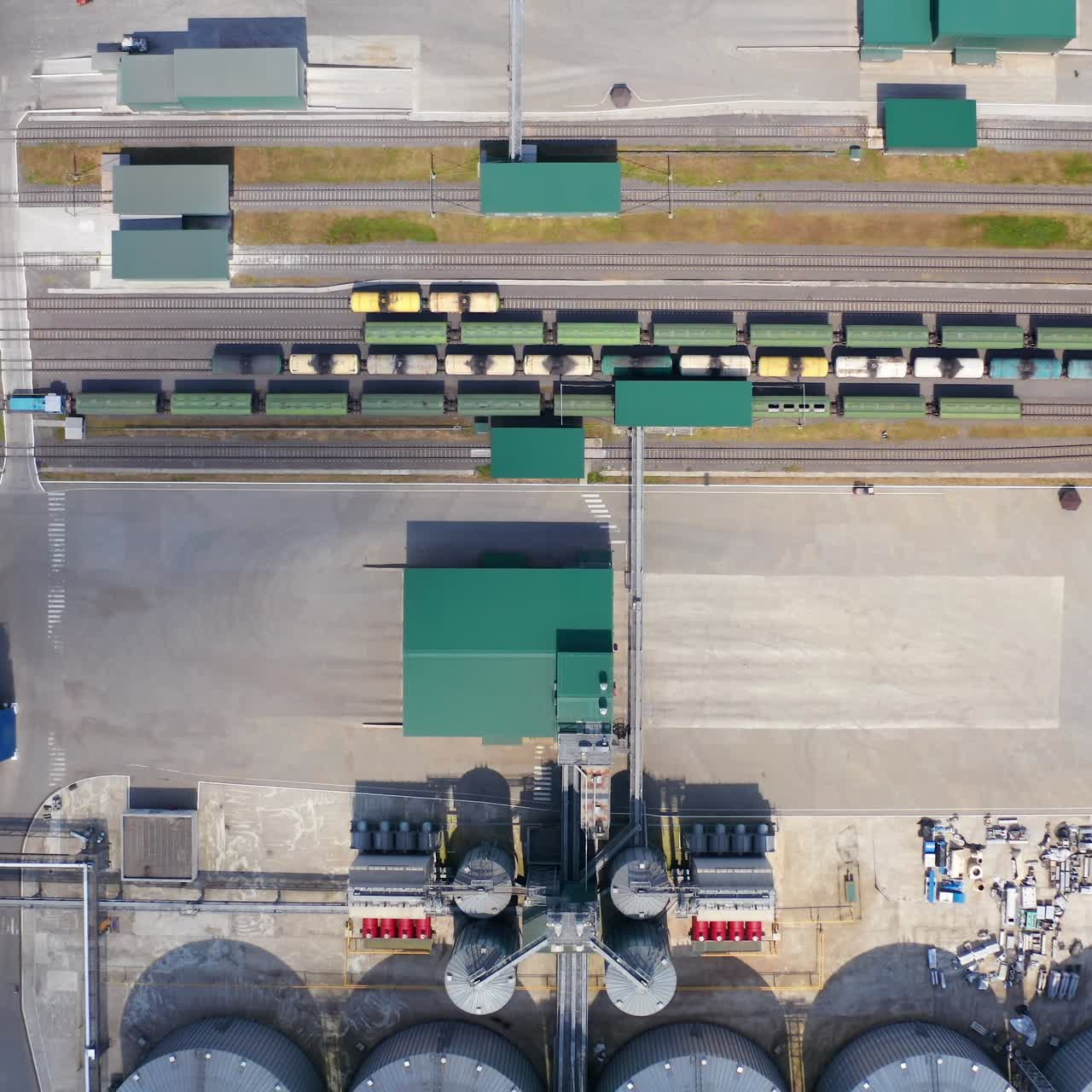 Large metal granaries. Agriculture manufacturing plant . Agriculture grain silos storage tank. Grain elevator on factory. Top aerial view