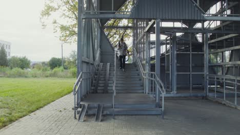 person walking up stairs with bicycle