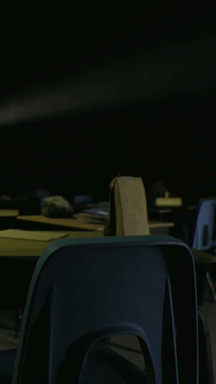 Students leave bags on chairs in an empty classroom during the afternoon